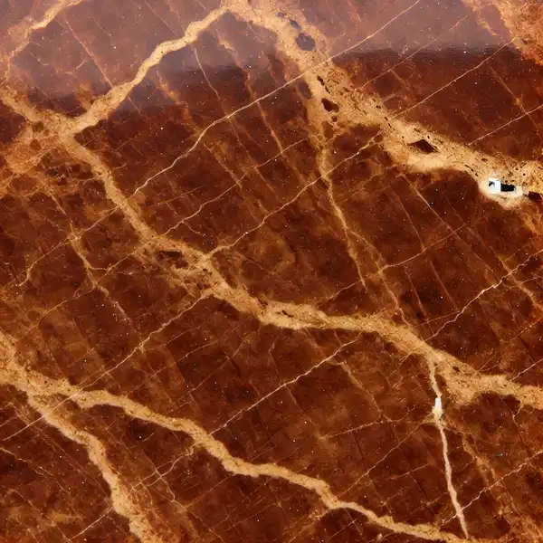 A close up view of Emperador marble with a deep brown background and lighter caramel like veins flowing through it